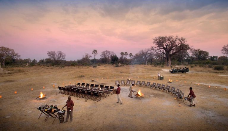 A starlit dinner under open skies is a highlight at Sandibe camp