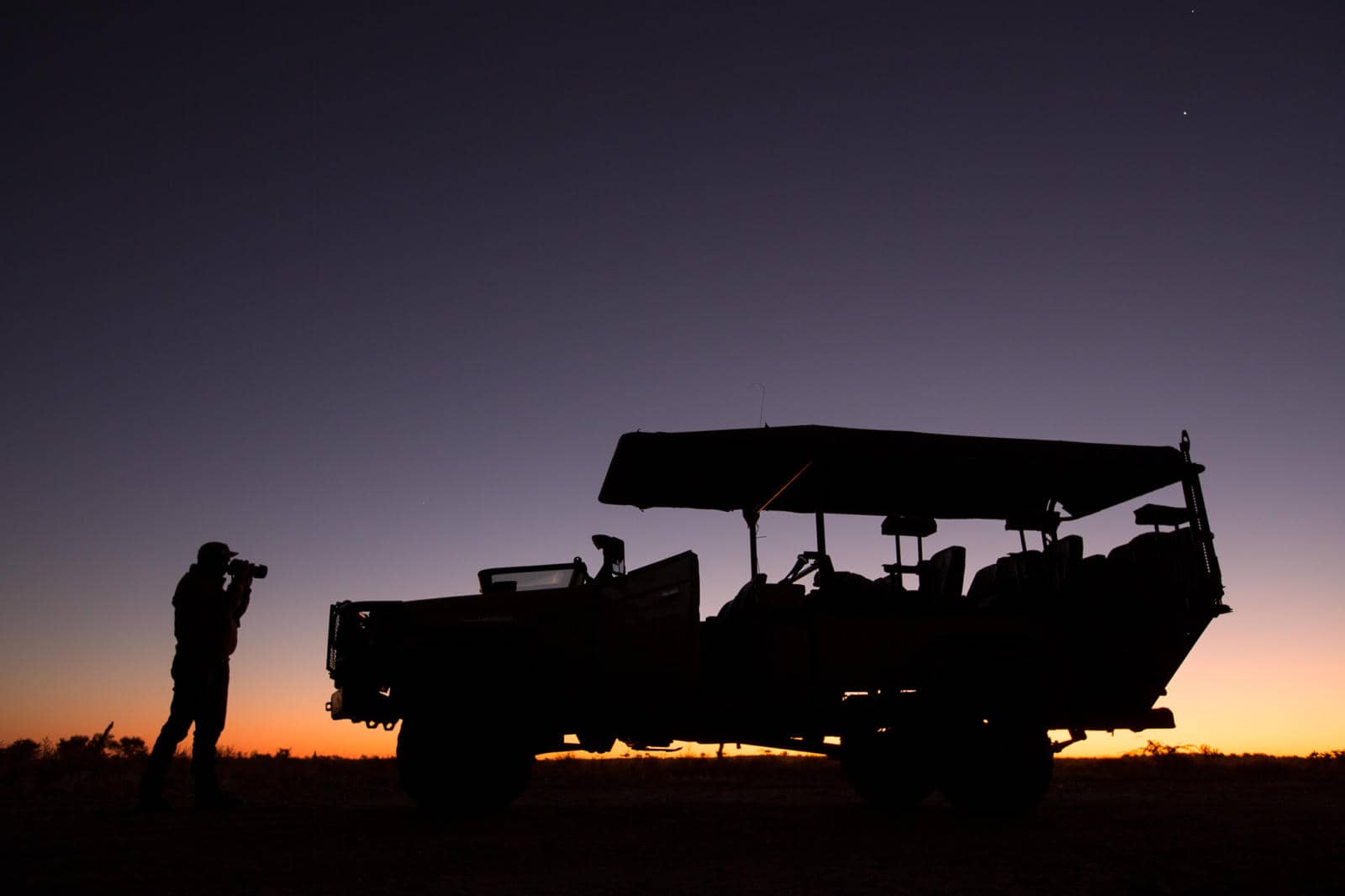 Silhouetted Letaka safari vehicle at twilight