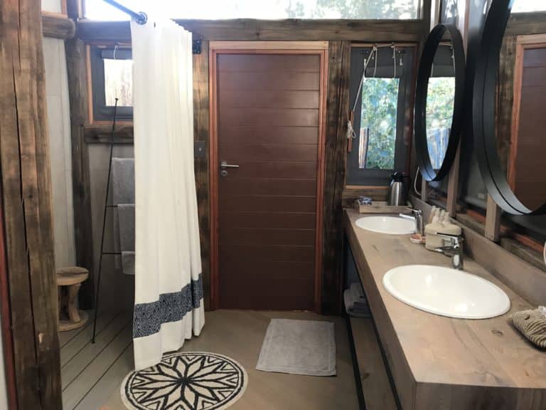 En suite bathrooms at Splash display twin basins and indoor and outdoor showers