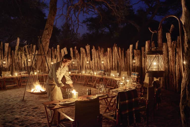 Dinner by lantern light in a traditional African boma at Savute Elephant Lodge