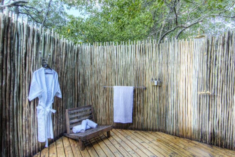 The outside shower area accompanies each guest suite at Okuti Camp