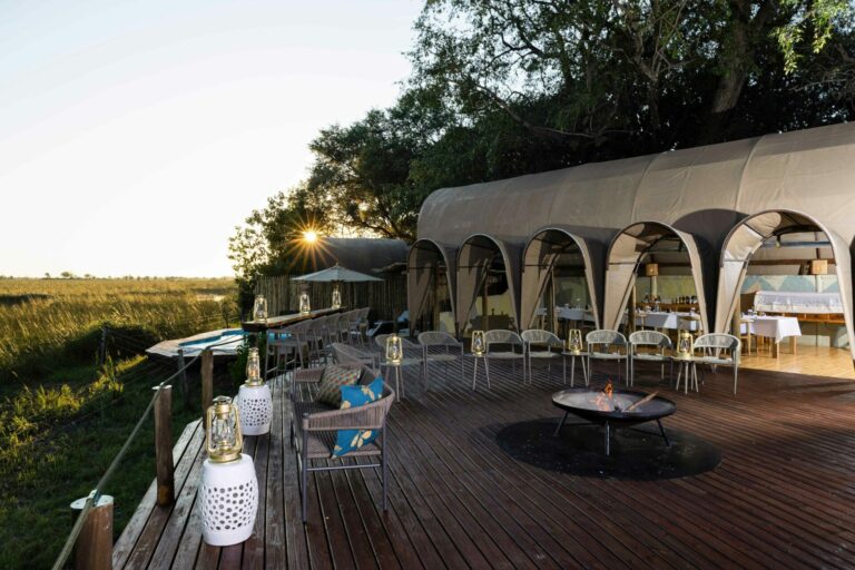 The dining area and fire deck at Okuti Camp offer sweeping views of the Okavango