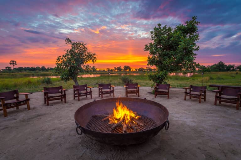 Fire pit focal against African sunset at Qorokwe Camp
