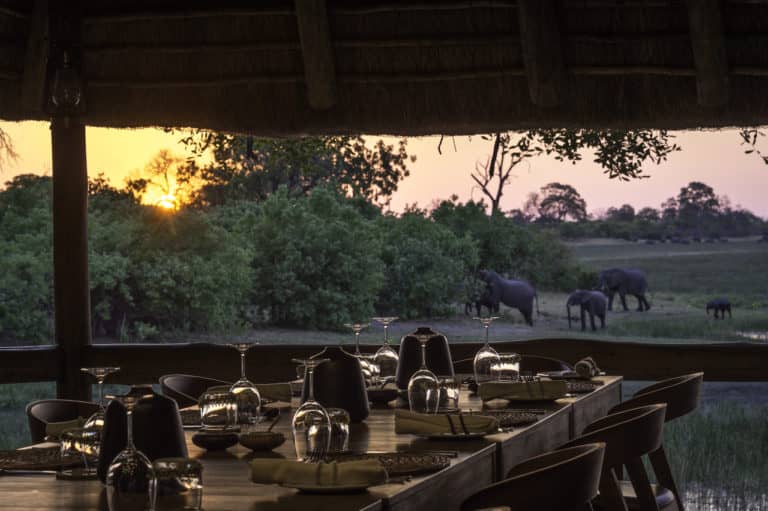 The dining area at Savuti Camp with a sunset view