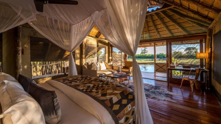 Interior of raised luxury room with outside view at Savuti Camp