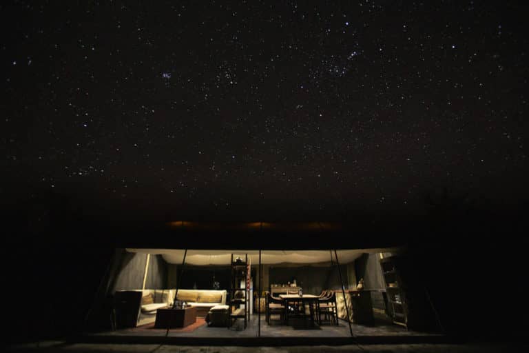 Light of the Migration Expeditions Camp against the night sky