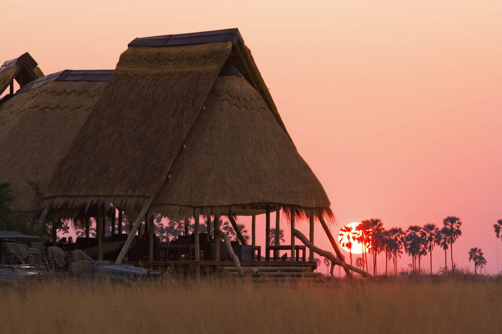 The thatched Selinda Camp at dusk