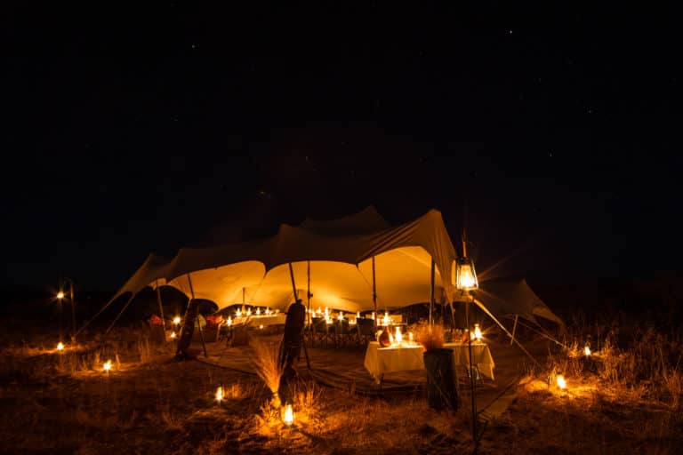 Pride of Africa guest tent on mobile safari viewed by night