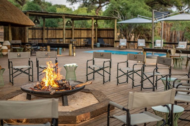 The large main deck at Mogotlho Safari Lodge features a fire pit overlooking the river